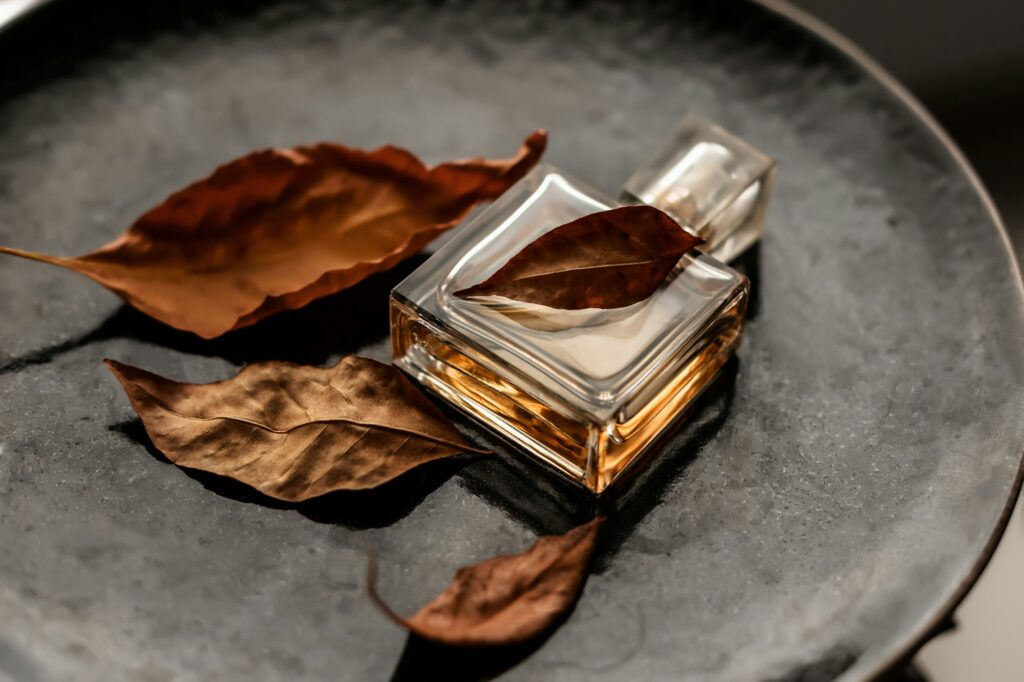 bottle of women's eau de parfum with autumn leaves